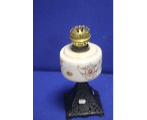A VINTAGE PARAFFIN LAMP WITH METAL BASE