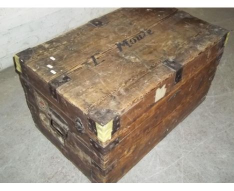 AN ANTIQUE WOODEN TRAVEL TRUNK
