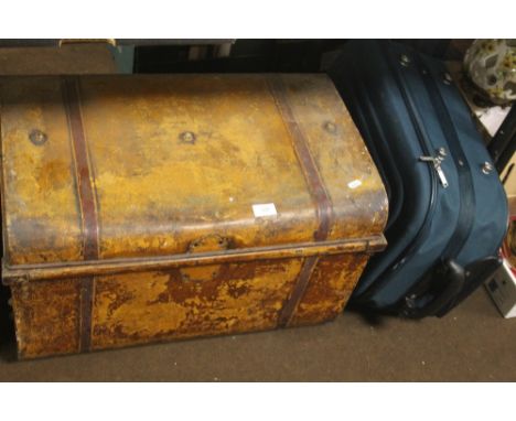 A TIN TRUNK AND A MODERN SUITCASE