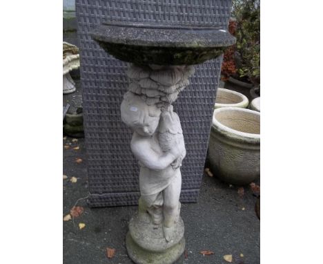 A CONCRETE BIRD BATH, PLANTER DEPICTING A BOY HOLDING A FISH