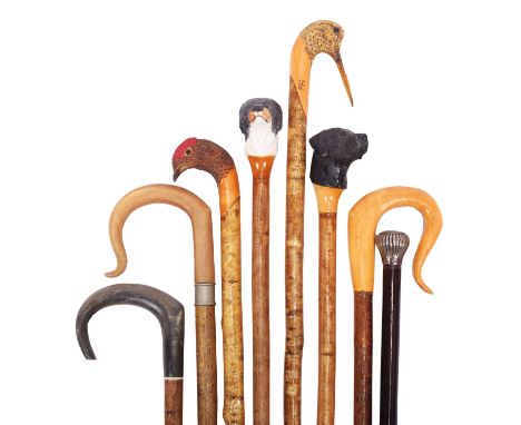 Natural History: A Collection of Carved Walking Sticks and Others, modern, four carved wooden handled walking sticks, one wit