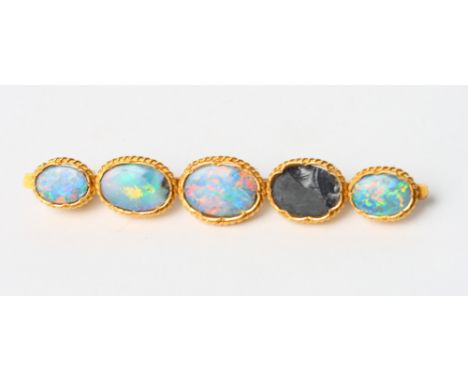 An Eastern high carat yellow gold and opal bar brooch (one stone missing)