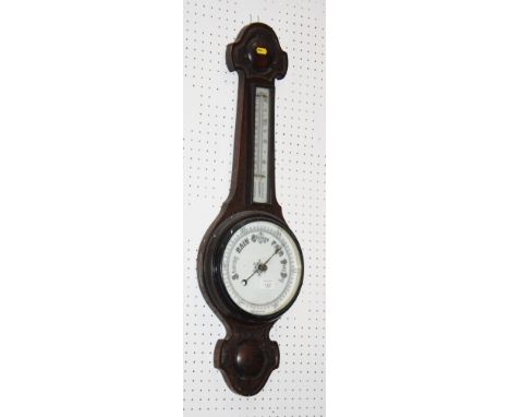 An aneroid barometer in oak case