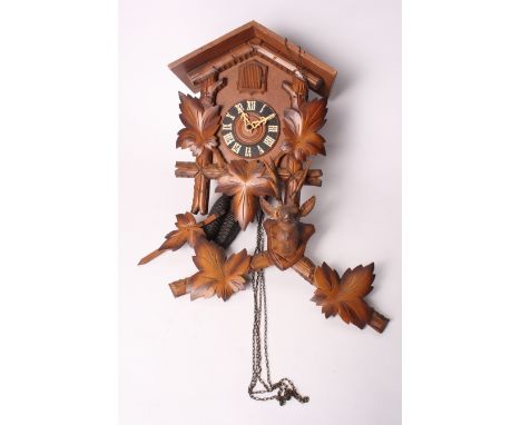 A Black Forest cuckoo clock with carved stag's head finial