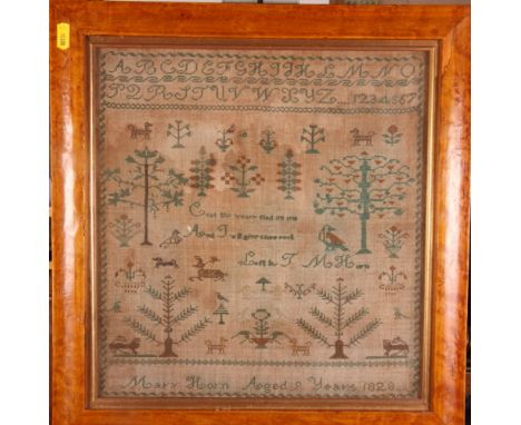 A 19th Century cross stitch sampler worked alphabet, trees and animals by Mary Horn aged nine years 1828