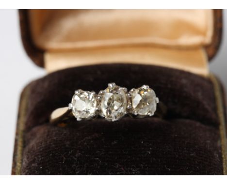 An 18ct gold three stone old cut diamond ring