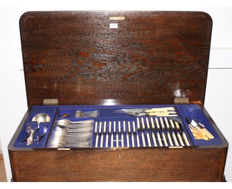 A suite of Elkington silver plated cutlery and flatware, in oak table canteen, on cabriole supports