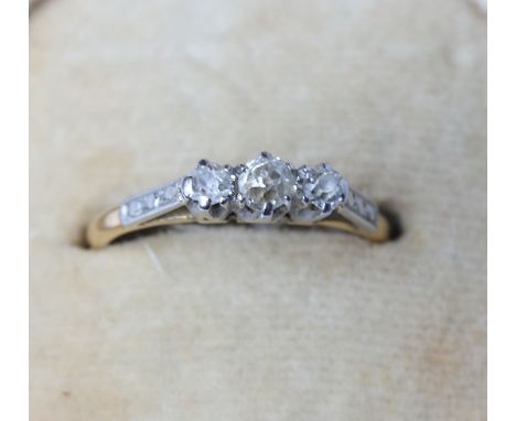 An 18ct gold three stone diamond ring