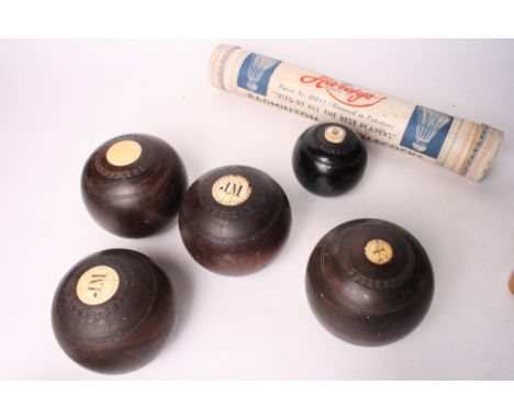A set of lignum vitae lawn bowls, a tube of shuttlecocks, a pair of vintage wooden ice skates and a wooden cribbage marker