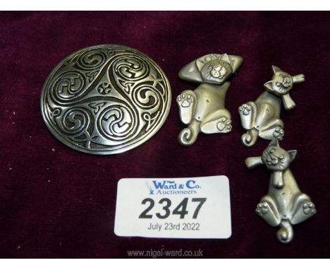A Past Times pewter Celtic swirl brooch inspired by the Book of Kells, together with Cat earrings and brooch set.