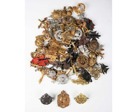 A large collection of 20th century British Army cap badges, including blackened brass Royal Australian Air Force, Royal New Z