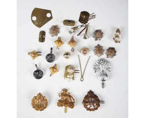 A large collection of 20th century British Army cap badges, including Royal Flying Corps, Queen Mary's Army Auxiliary Corps a