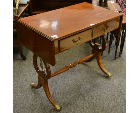 A reproduction mahogany sofa table, two cockbeaded drawers to frieze, lyre supports, reeded splayed legs, brass lion paw feet