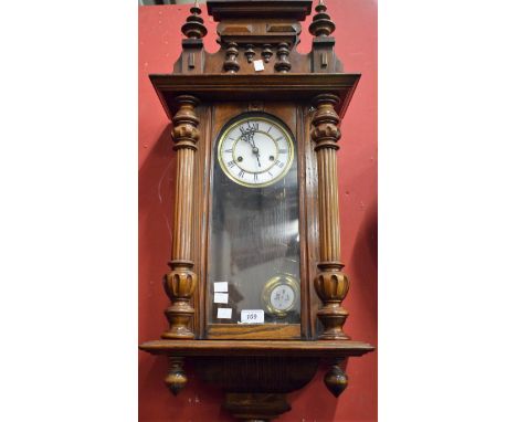 A mahogany Vienna wall clock, Roman numerals, turned and fluted pilasters.