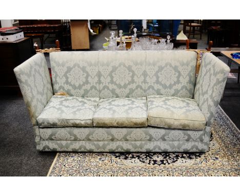 A knowle three seat sofa, upholstered in mint green fabric