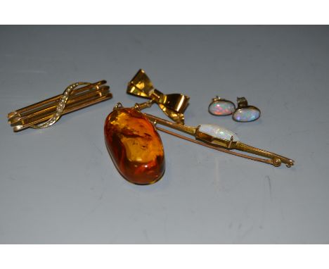 A 9ct gold and opal bar brooch;  a 9ct brooch;  an amber type pendant;  etc 