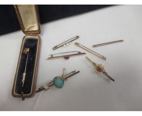 Four gem set bar brooches, two gold tie pins and a sapphire set stick pin  