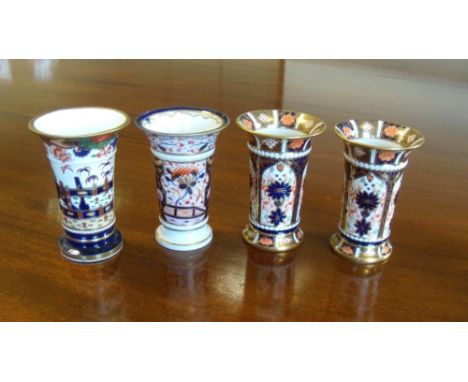 A pair of Crown Derby spill vases, date code for 1920, another Derby and a Spode spill vase, all decorated in the Imari palet