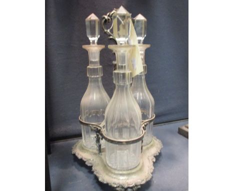 A Victorian electroplate three bottle decanter stand  