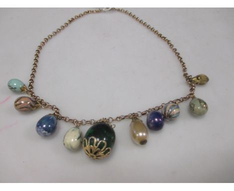 A gold belcher link necklace suspended with a fringe of low grade enamel 'egg' ornaments  