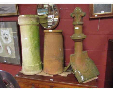 Six various pottery chimney pots and a shaped ridge finial tile  
