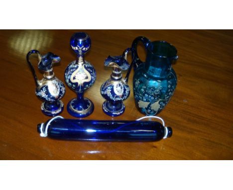 A blue glass rolling pin, a pair and another enamelled blue glass jug together with a vase similar, 24.5cm high (5)  