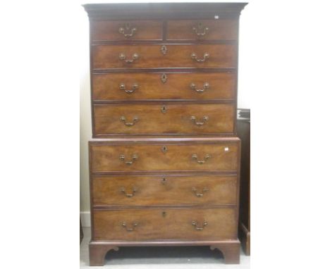 A George III mahogany chest on chest with foliate carved blind fret cornice, gilt brass handles, on bracket feet  