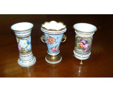 A spill vase attributed to Nantgarw, another to Coalport and the third by Derby, the first painted with a band of flowers on 