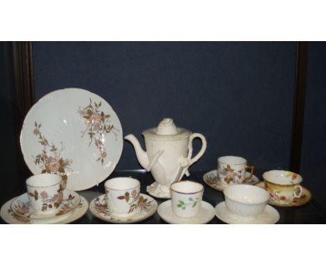 A Moore Bros coffee pot of floral form applied with lily pads, six cups, six saucers, a tea plate and a sandwich plate and a 