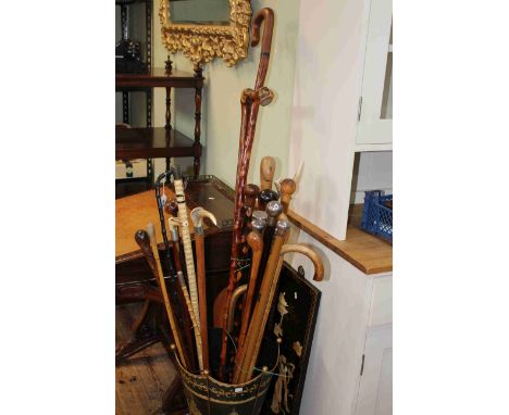 Collection of walking sticks including shark vertebrae, silver collared, wood knots, horn, etc; together with stick stand and