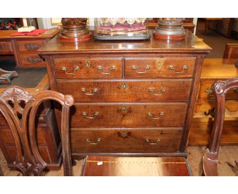 Georgian oak chest of two short above three long graduated drawers on shaped bracket feet, 102cm by 106cm.