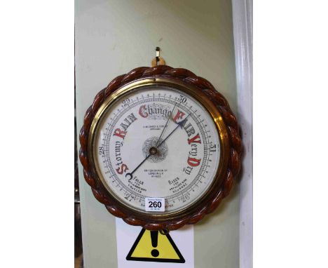 Carved oak circular rope twist barometer.