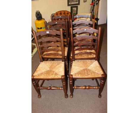 Set of six rush seated ladder back dining chairs.