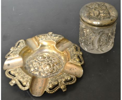 An Edwardian shaped circular ashtray, cast with crows and roses, Birmingham 1901; a dressing table trinket jar, Birmingham 19