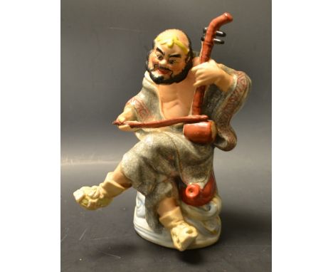 A Japanese figure, immortal playing an instrument