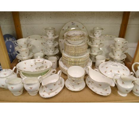 A Staffordshire fine bone china dinner and tea service decorated with roses, comprising vegetable terrines, teapots, cups, sa