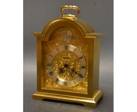 A lacquered brass dome topped mantel clock, by Swiza, Roman numerals, with alarm 