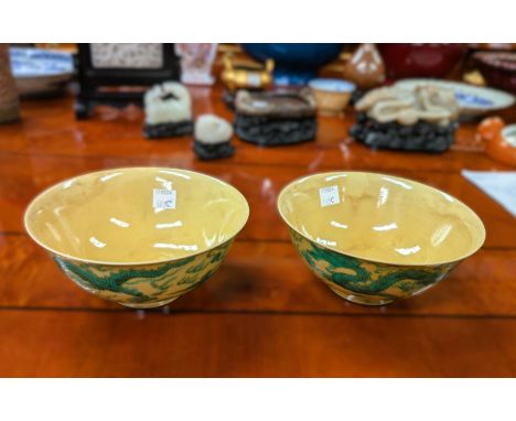 A pair of Chinese yellow ground bowls with green dragons in clouds, seal marks to base, dia. 14.5cm.All in good condition.WE 