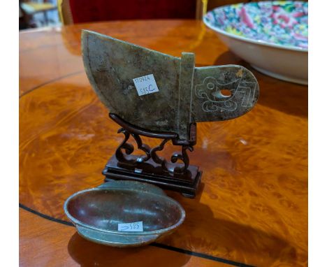 A Chinese carved jade scimitar shaped hardstone panel on stand, length 15cm; a Chinese jade coloured hardstone bowl, length 9