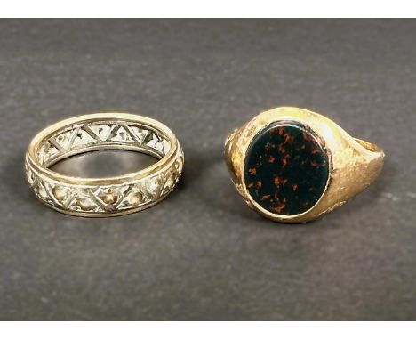An 18 carat hallmarked signet ring with agate stone, 5grams, size P; an eternity ring set with clear stones (unmarked, tests 