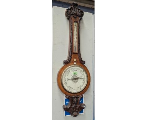 A large 19th Century carved walnut mercury column barometer with thermometer and white scale.Condition report:In good origina