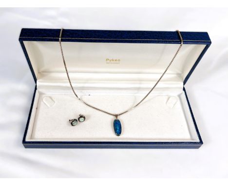 An elongated silver cased black opal pendant on box chain, clasp stamped 925 and a pair of opal stud earrings.