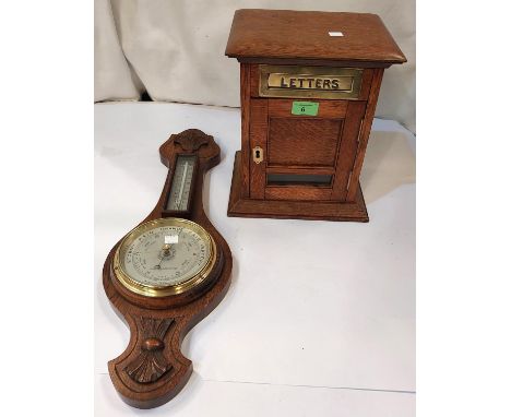 A golden oak table top "letter box"; an aneroid barometer.Condition report:Dimensions: 24x19x30cm high. In good condition, th