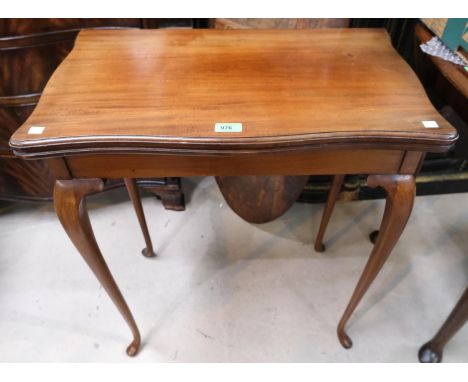 A mahogany folding card table on cabriole legs with green baize interior; a 19th Century mahogany two height what-not, with d