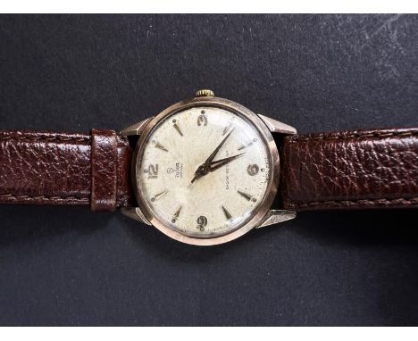 A gents Tudor/Rolex 9 carat hallmarked gold wrist watch on leather strap.