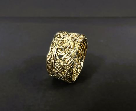 A gent's 1970's 18ct hallmarked gold ring, the wide band formed from intricately woven gold strands, giving a pierced effect,