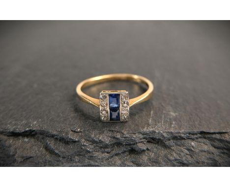 An Art Deco style ring with sapphires and two rows of 4 square cut diamonds set vertically, marks unclear, tests as circa 18 