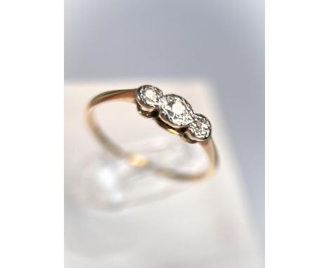 A yellow metal ring stamped 18ct set with 3 diamonds in illusion settings, 1.6gm, size 'N'
