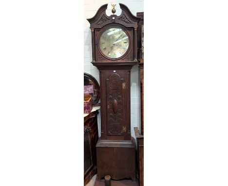 A late 18th Century/early 19th Century carved oak longcase clock with swan neck pediment, ball finial and reeded columns to t