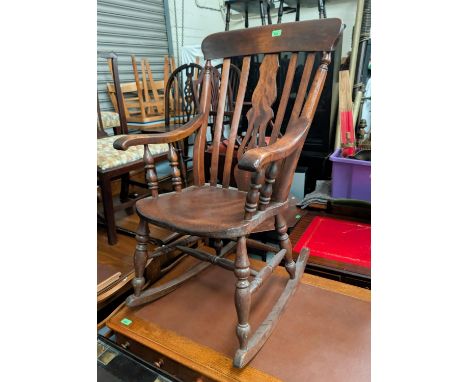 A fiddle back rocking armchair; a 19th century ladder back rush seat chair.